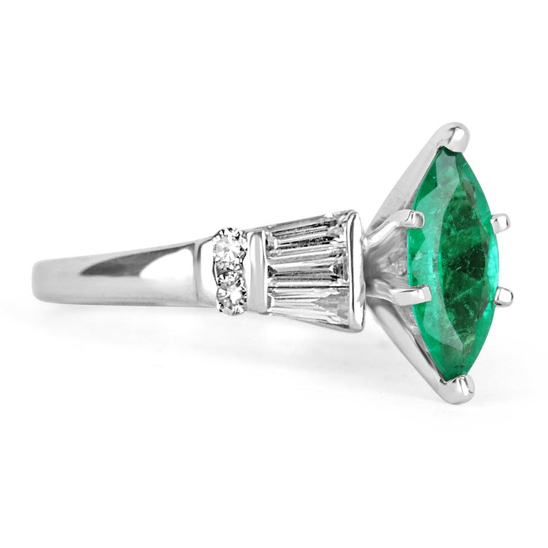 14K Colombian Emerald and diamond ring featuring a marquise cut emerald and tapered baguette diamonds on a sleek band.