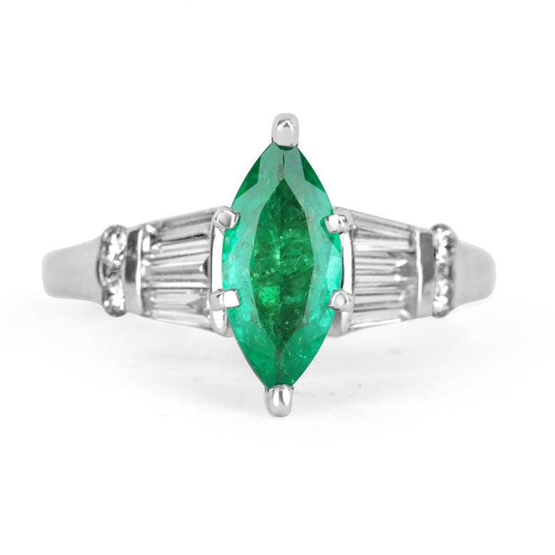 14K Colombian Emerald and diamond marquise cut ring featuring tapered baguette diamonds, showcasing elegant jewelry craftsmanship.