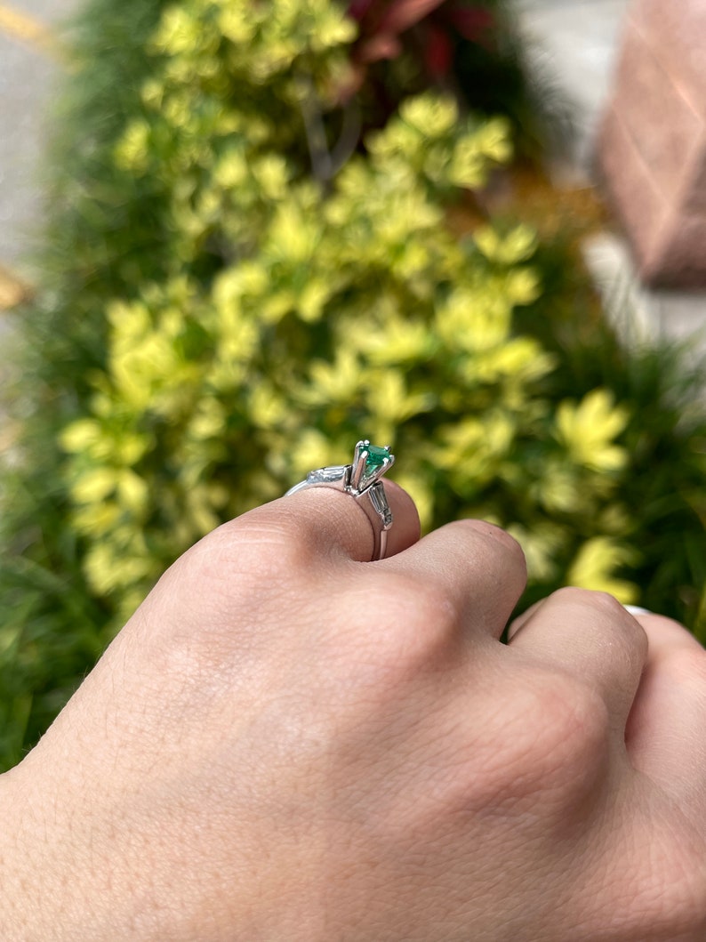 14K Colombian Emerald and diamond ring featuring a marquise cut emerald with tapered baguette diamonds, elegant jewelry design