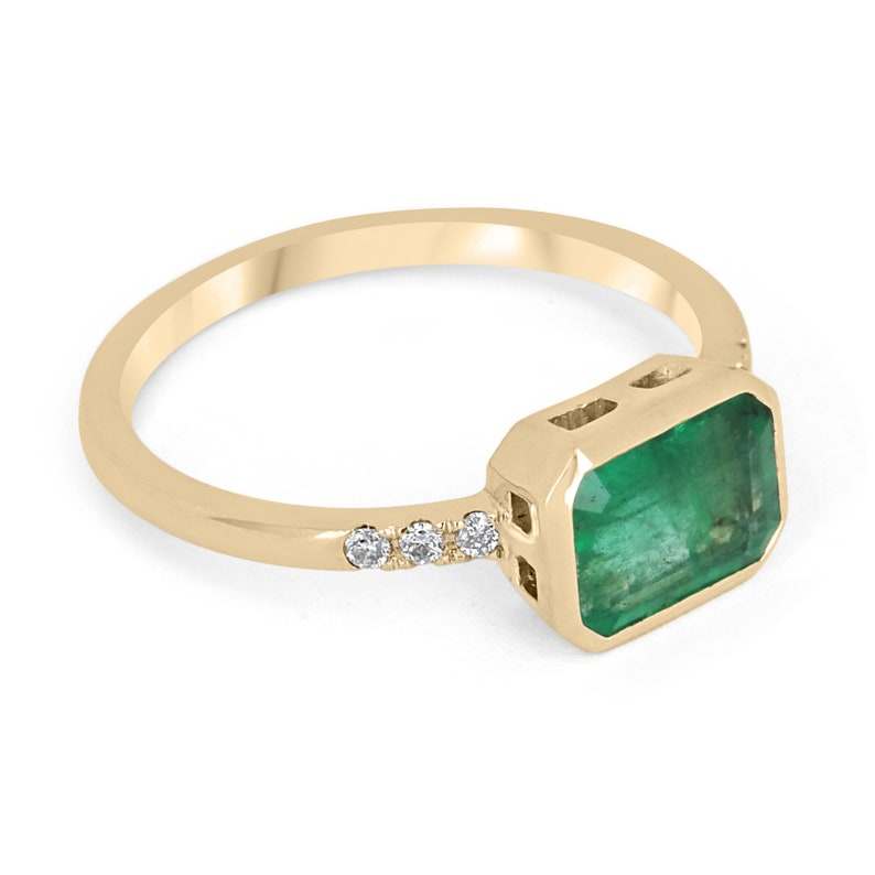 Colombian Emerald private link ring featuring a 1.15tcw emerald cut emerald with diamond accents in 14K bezel setting