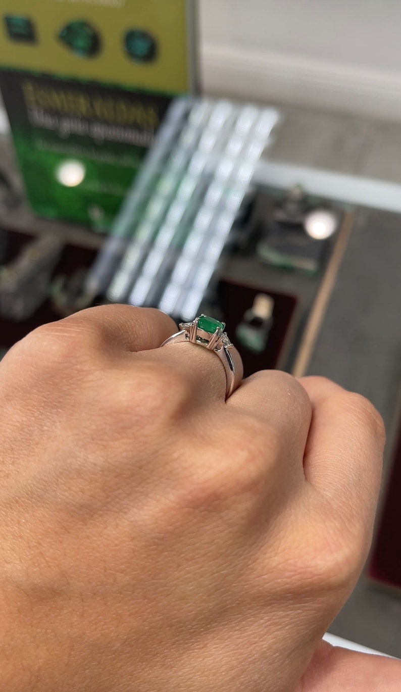18K Colombian Emerald and diamond cushion cut three-stone ring with 1.48 tcw, featuring vibrant green emeralds and sparkling diamonds.