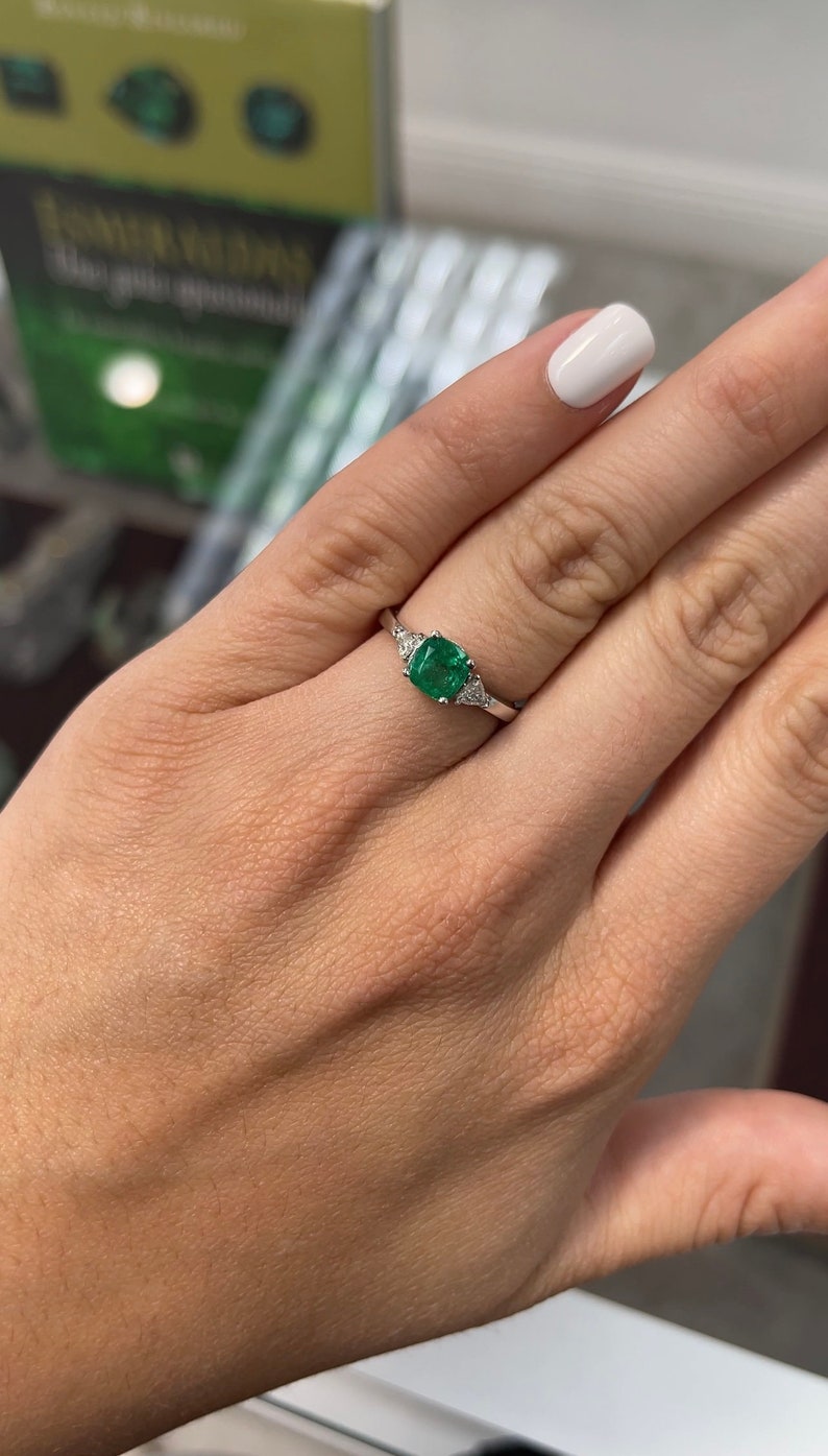 18K Colombian Emerald cushion cut three stone diamond ring with 1.48tcw, featuring vibrant green emeralds and sparkling diamonds.