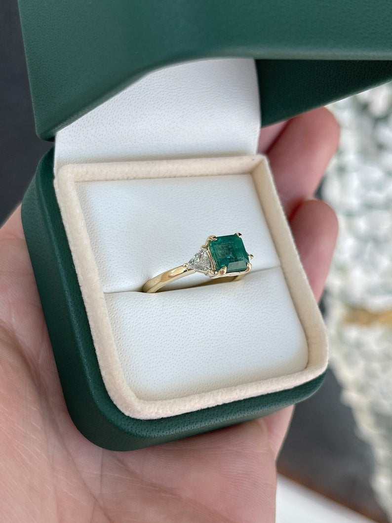 14K gold 3-stone engagement ring with lush green asscher emerald and trillion cut diamond accents, designed by Colombian Emerald.