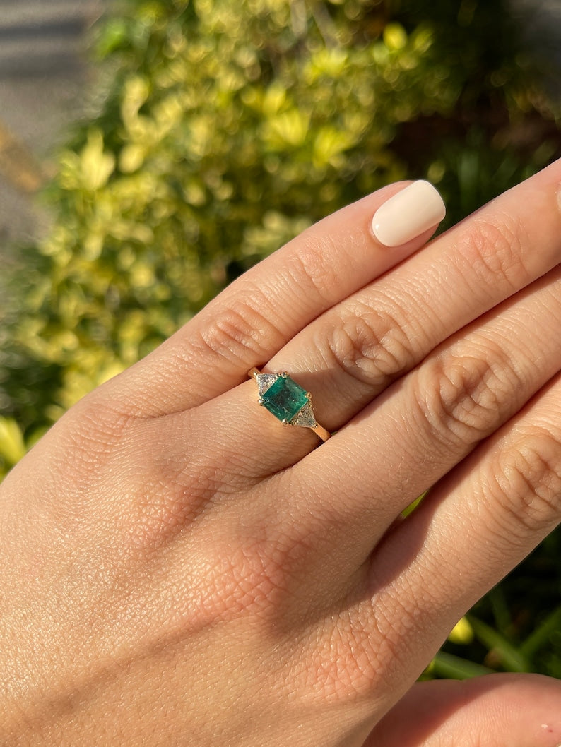 14K gold 3-stone engagement ring with lush green Asscher emerald and trillion-cut diamond accents, Colombian Emerald brand.