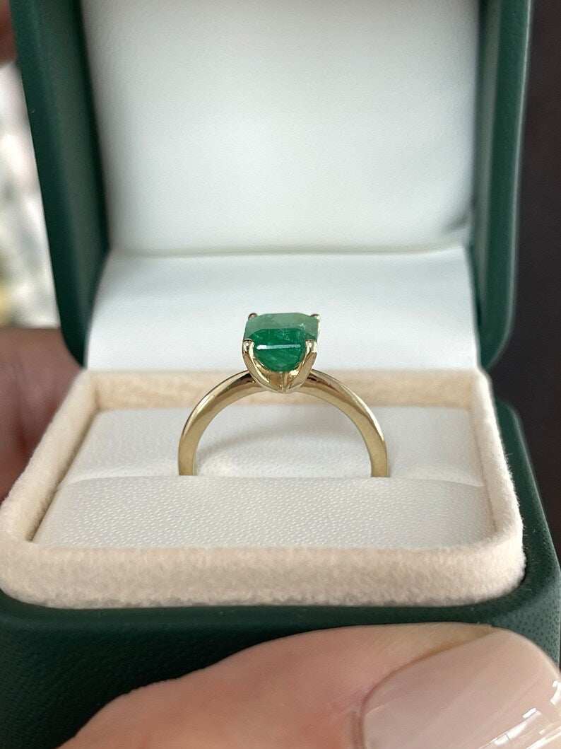 14K gold solitaire ring with 2.10cts natural emerald gemstone, four-prong setting, designed for right hand wear.