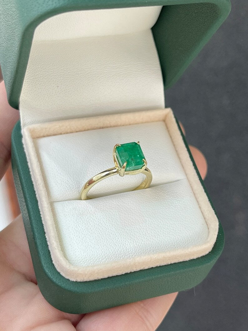 14K gold emerald cut solitaire engagement ring with a 2.65ct Colombian emerald, showcasing a classic and elegant design.