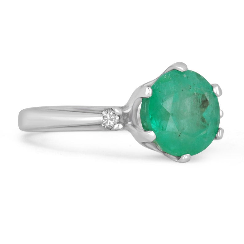 14K gold ring featuring 3.21tcw Colombian emeralds and diamond accents in a round cut three-stone design.