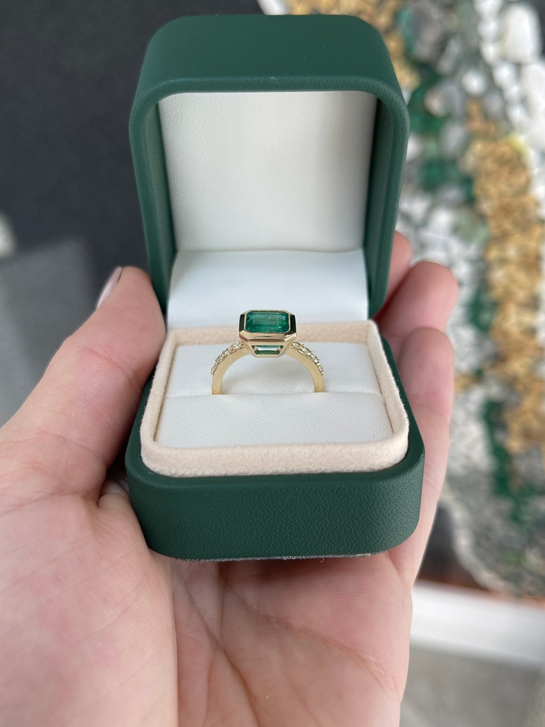 Colombian Emerald 3.22tcw 14K gold square bezel set Asscher cut emerald with diamond accents right-hand solitaire ring