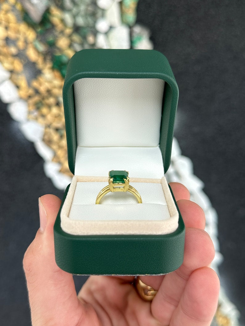 Colombian Emerald gold ring featuring a 3.28ct deep dark green emerald-cut solitaire gemstone in a double prong setting.
