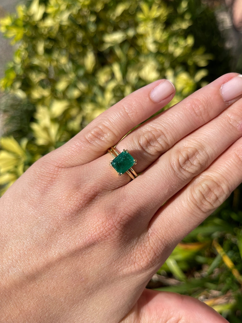Deep dark green emerald cut solitaire gold ring with 3.28ct Colombian emerald in 18K gold with double prong setting.