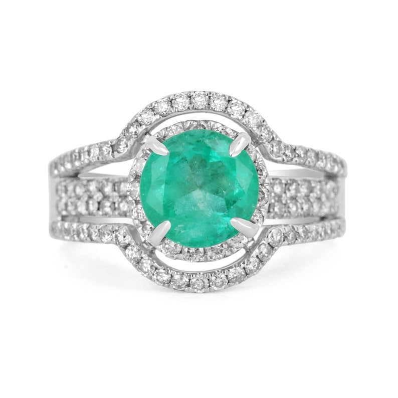 14K Colombian Emerald engagement ring with round-cut emerald, diamond halo, and intricate band design.