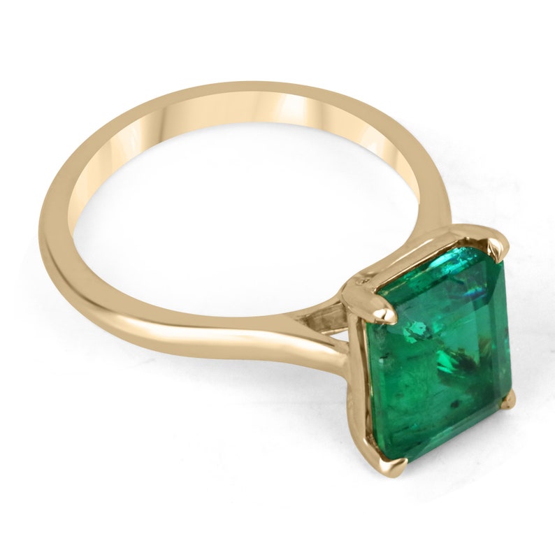 18K gold emerald cut solitaire engagement ring with a 3.84 carat Colombian emerald, showcasing a classic and elegant design.