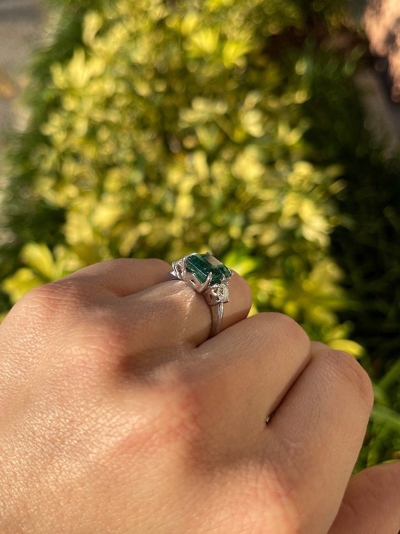 14K gold 4.90tcw dark green emerald and round diamond 3-stone engagement ring by Colombian Emerald, showcasing elegant gemstone details
