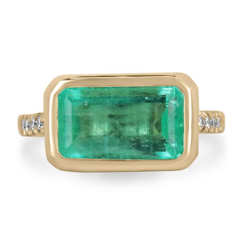 14K gold ring with emerald cut Colombian emerald and diamond accents