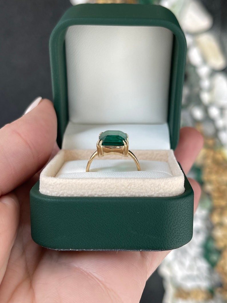 7.25 carat natural emerald solitaire engagement ring in 18K gold, featuring a classic Colombian emerald centerpiece.