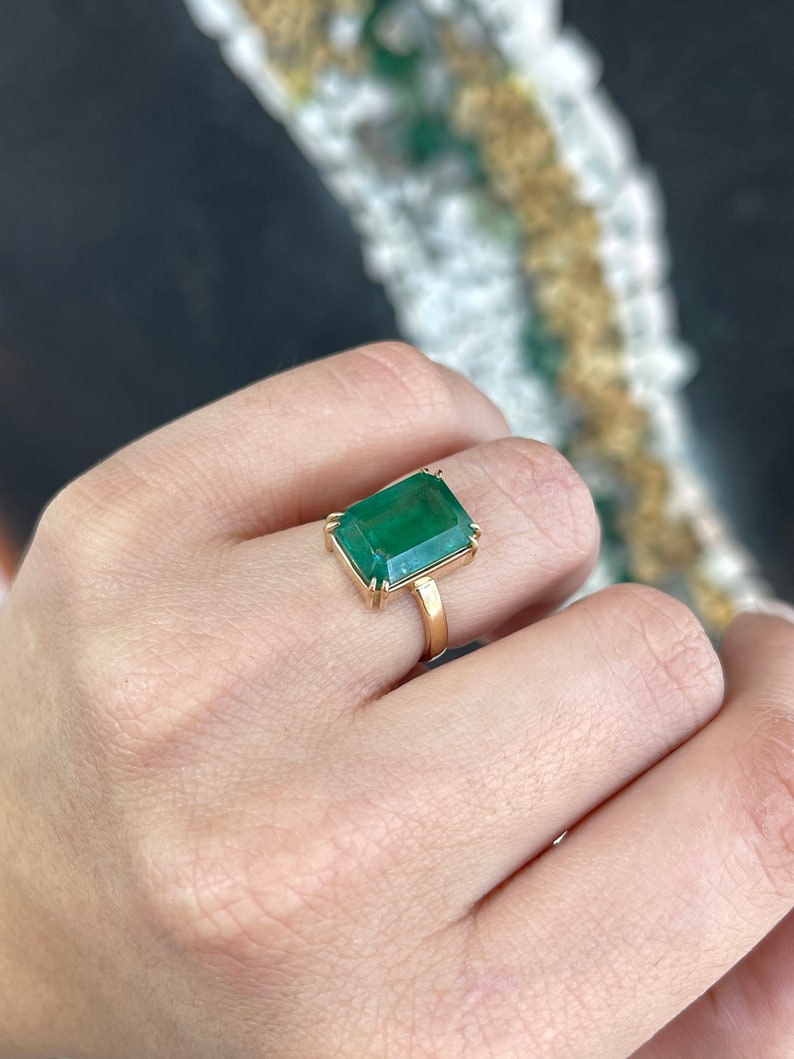 7.25 carat natural emerald solitaire engagement ring in 18K gold, featuring a classic Colombian emerald centerpiece.