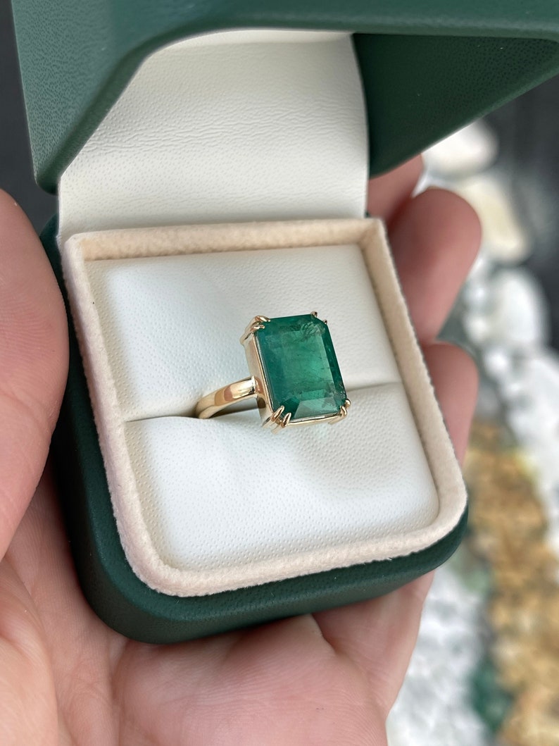 7.25 carat Colombian emerald solitaire engagement ring with 18K gold setting, featuring a classic natural emerald gemstone.