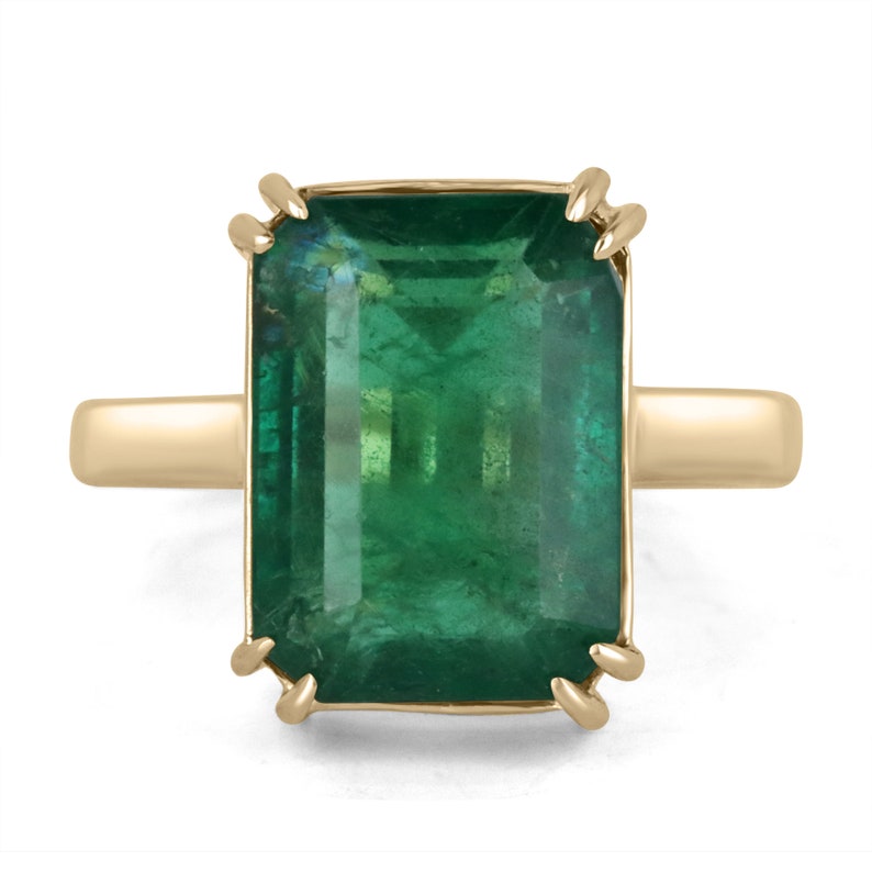 7.25cts 18K gold Colombian emerald solitaire engagement ring with a classic natural emerald center stone and elegant band.