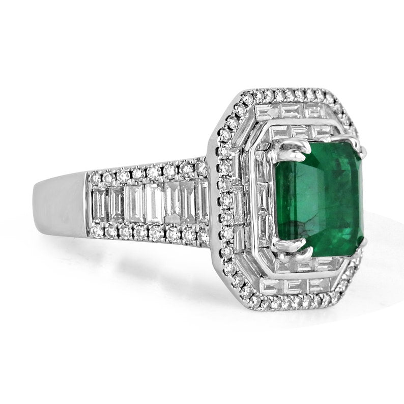Colombian Emerald 7.39tcw 18K white gold triple diamond halo anniversary ring with emerald and diamond accents.