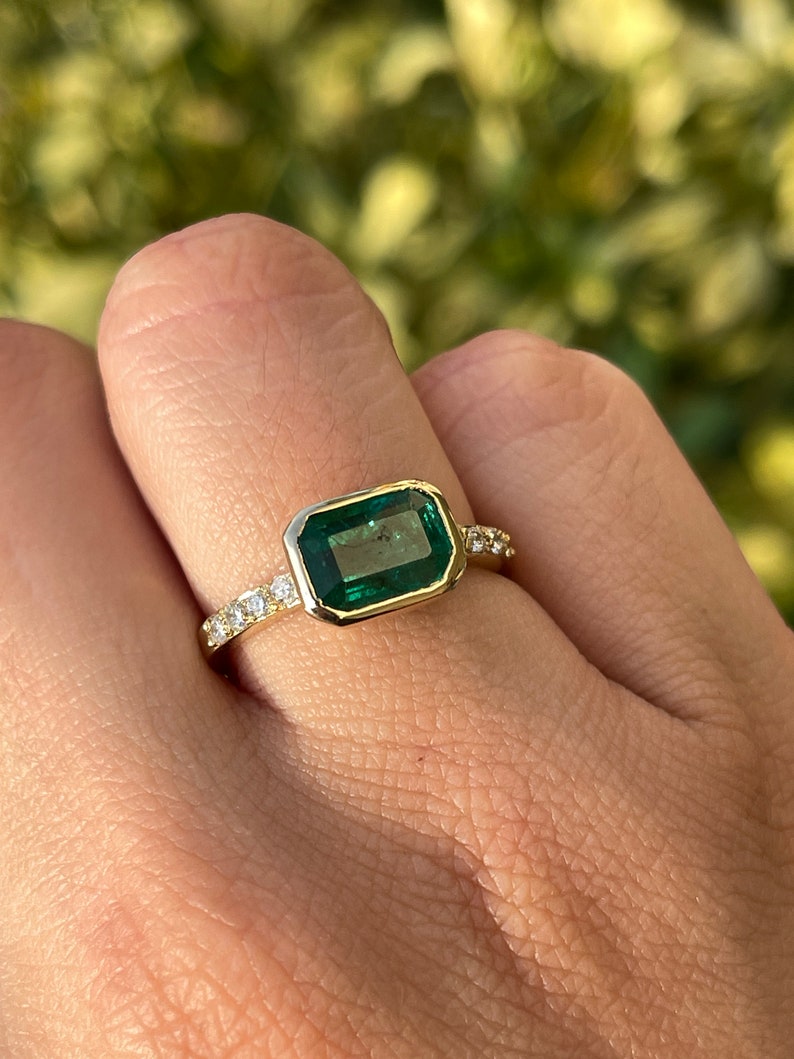 14K gold ring with natural emerald cut emerald and diamond shank, bezel set, from Colombian Emerald jewelry collection.