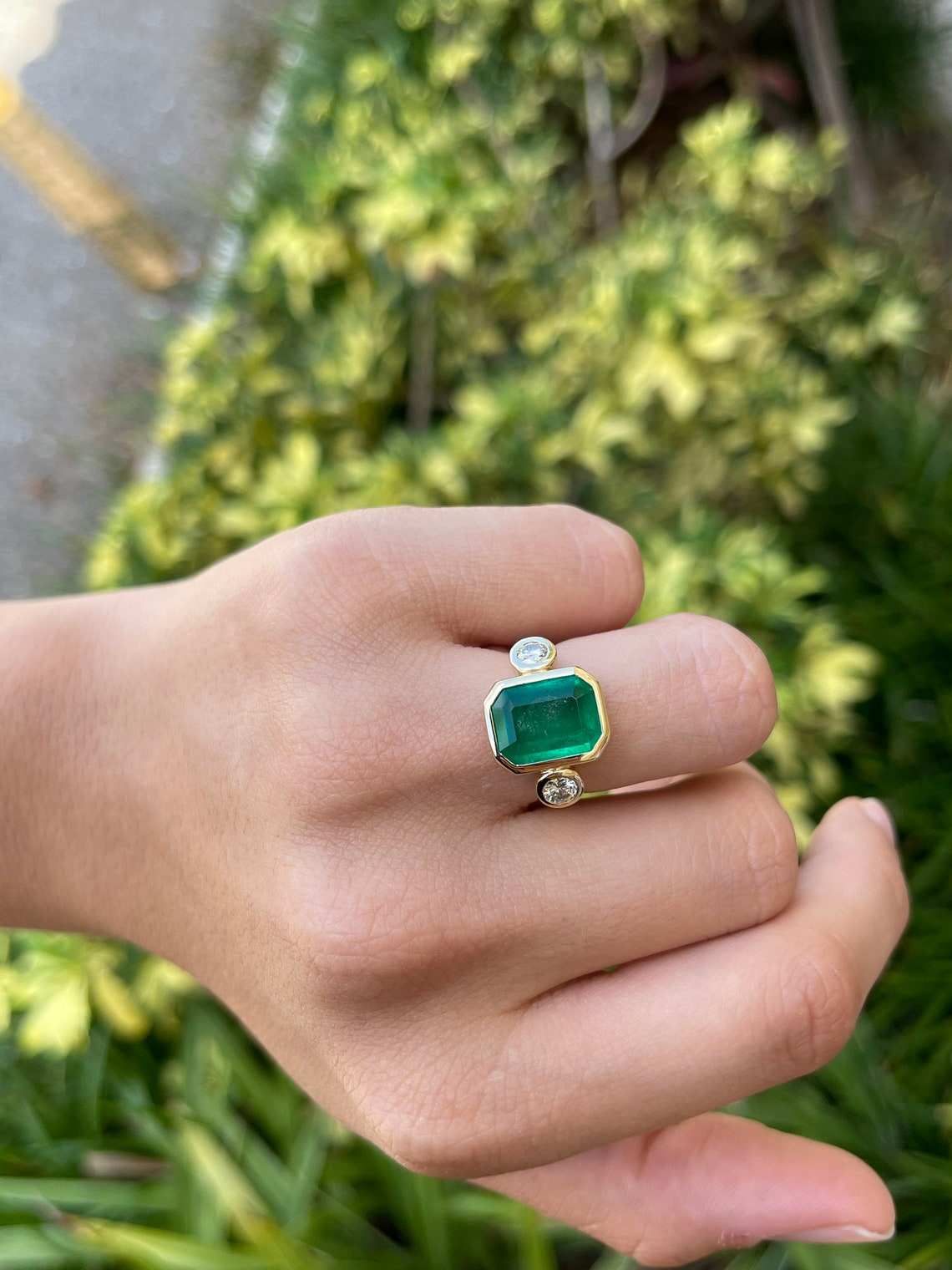 luxurious three stone emerald and diamond bezel ring 18K