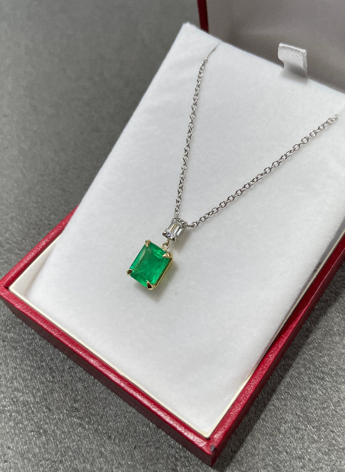 Elegant 18K Gold Necklace with Emerald Cut Colombian Emerald and Diamond Accents