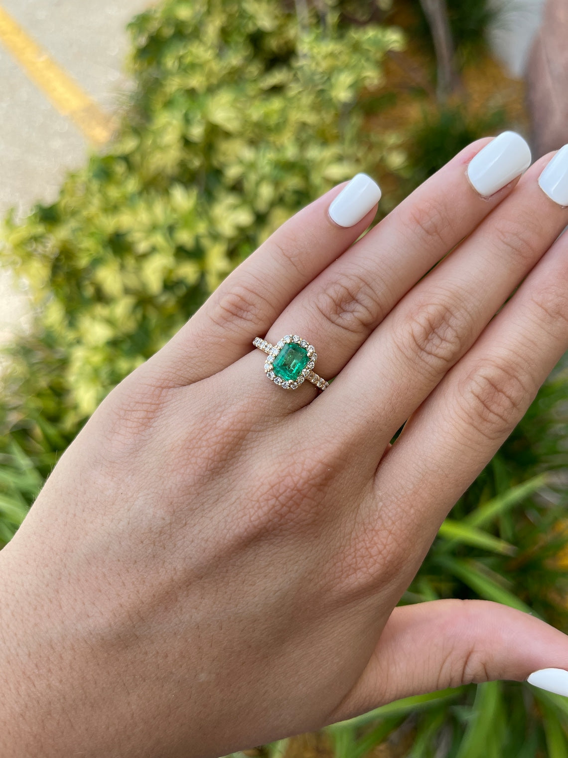 Emerald & Diamond Halo Engagement Ring on Hand