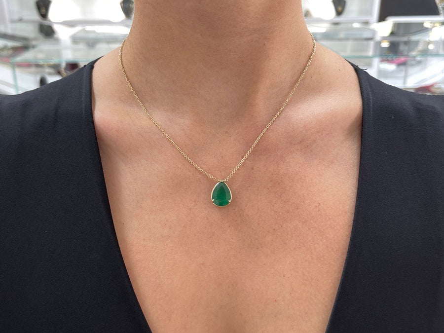 Emerald-Pear Cut Solitaire Gold Three Prong Stationary Necklace on Neck