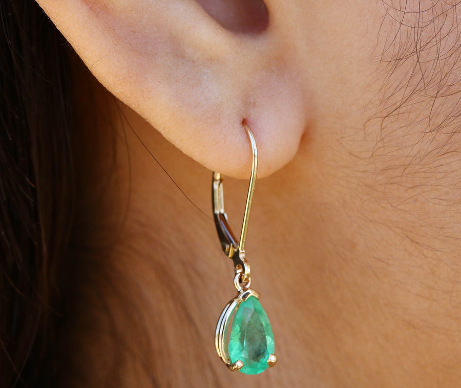 Earth mined 2.0 carat pear drop dangle earrings in 14K on ear