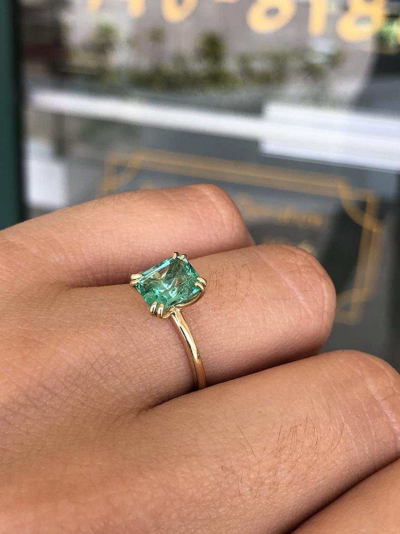 Celebrate Brilliance: 14K Gold Ring Featuring 1.80cts Double Claw Prong Colombian Emerald Solitaire