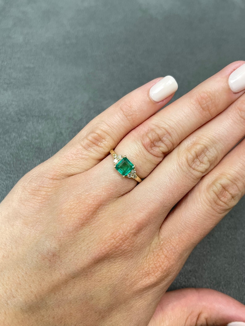 Celebrate Brilliance: 14K Gold Ring Featuring 1.30tcw Emerald Asscher Cut & Round Diamond Accent