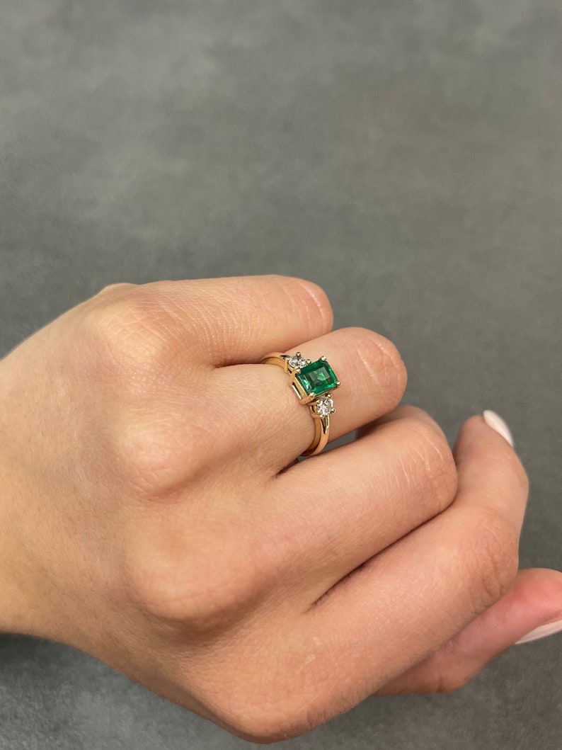 Celebrate Brilliance: 14K Gold Ring Featuring 1.25tcw Emerald Three Stone & Round Diamond Transparency