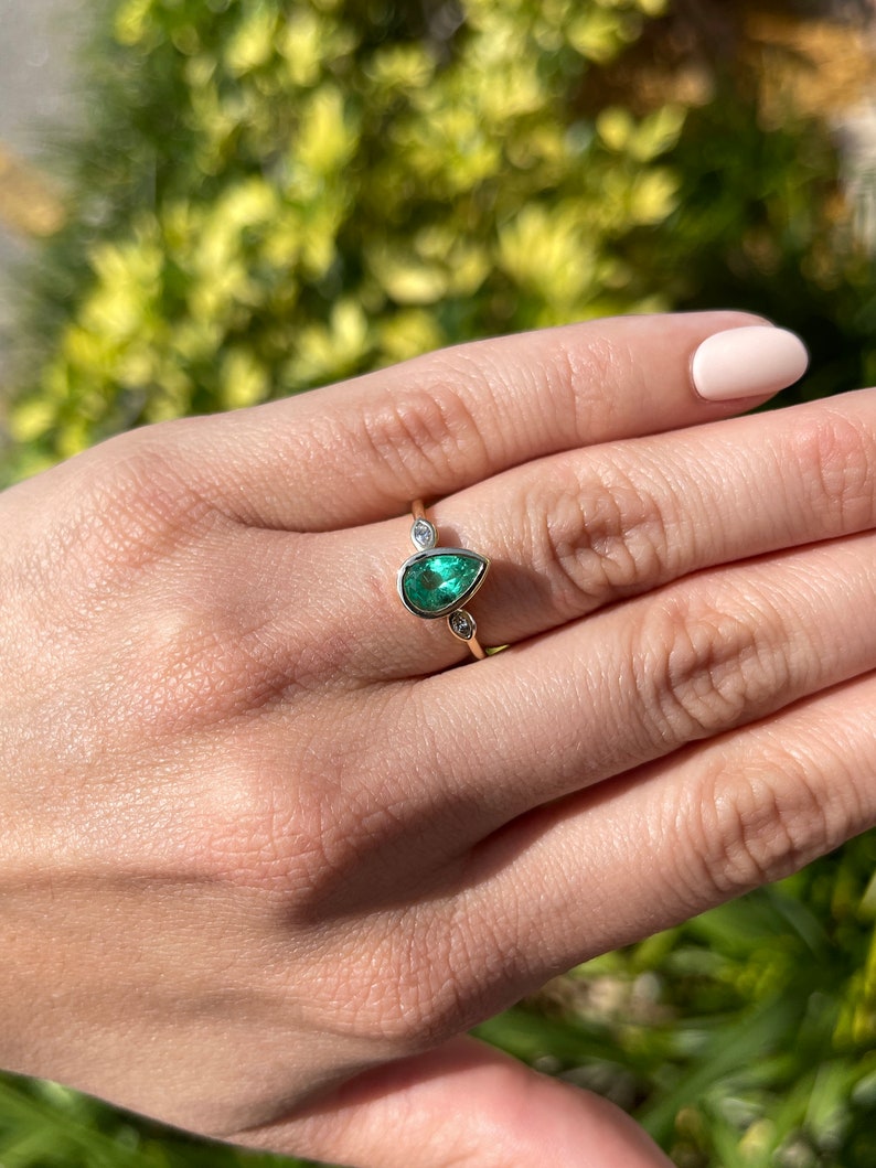 Celebrate Brilliance: 14K Gold Ring Featuring 1.17tcw Natural Emerald and Marquise Diamond Trio