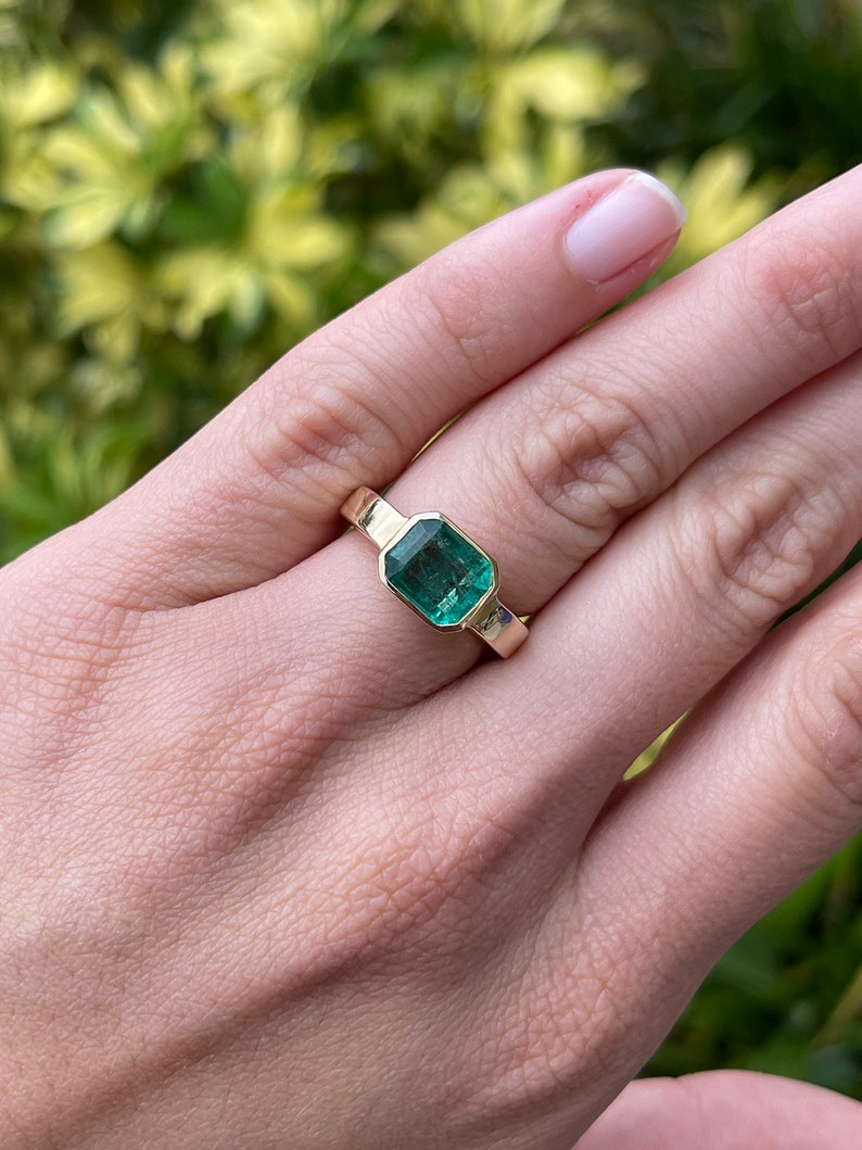 Natural Emerald Cut Dark Green Solitaire Engagement Ring on Hand