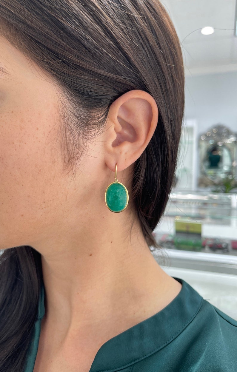 44.80tcw Deep Green Colombian Emerald HUGE Oval Hook Bezel Earrings 18K Yellow Gold on ear