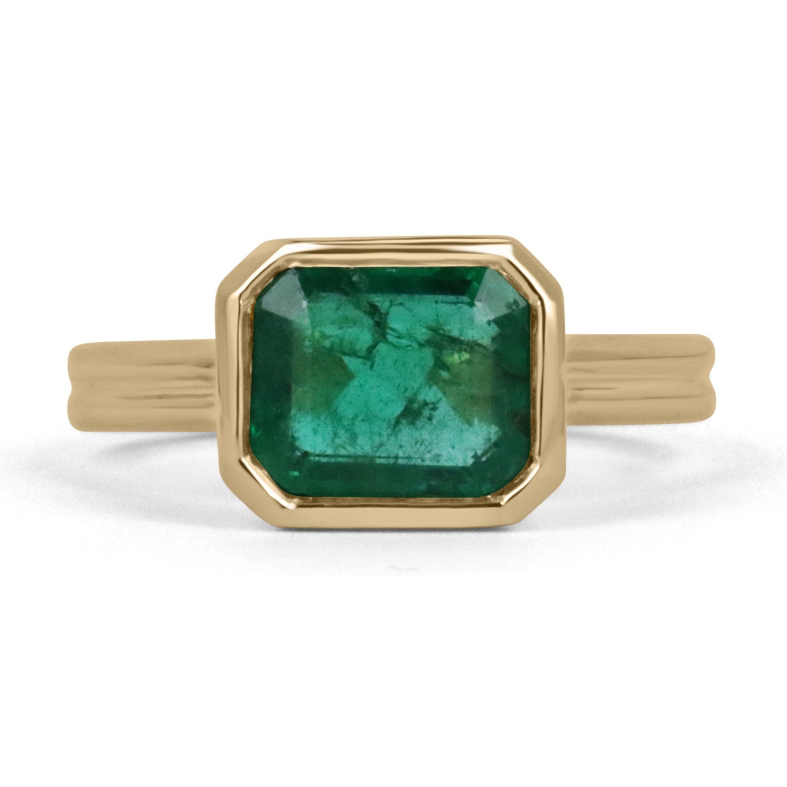 18K gold ring featuring a 2.75ct natural east-west dark vivid green emerald bezel solitaire from JR Colombian Emeralds.