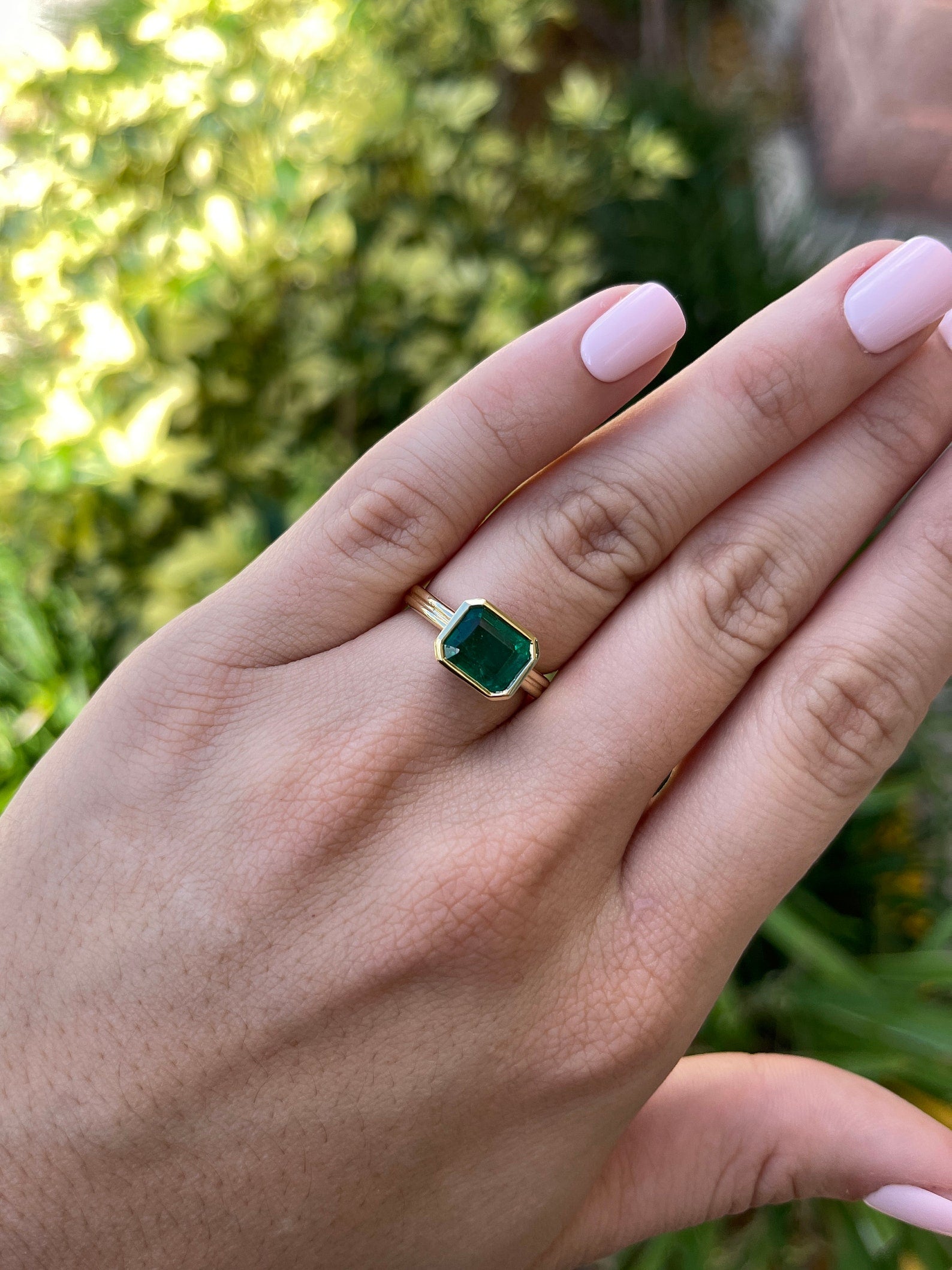 Dark vivid green emerald bezel solitaire ring with 2.75ct east-to-west cut, set in 18K gold by JR Colombian Emeralds.