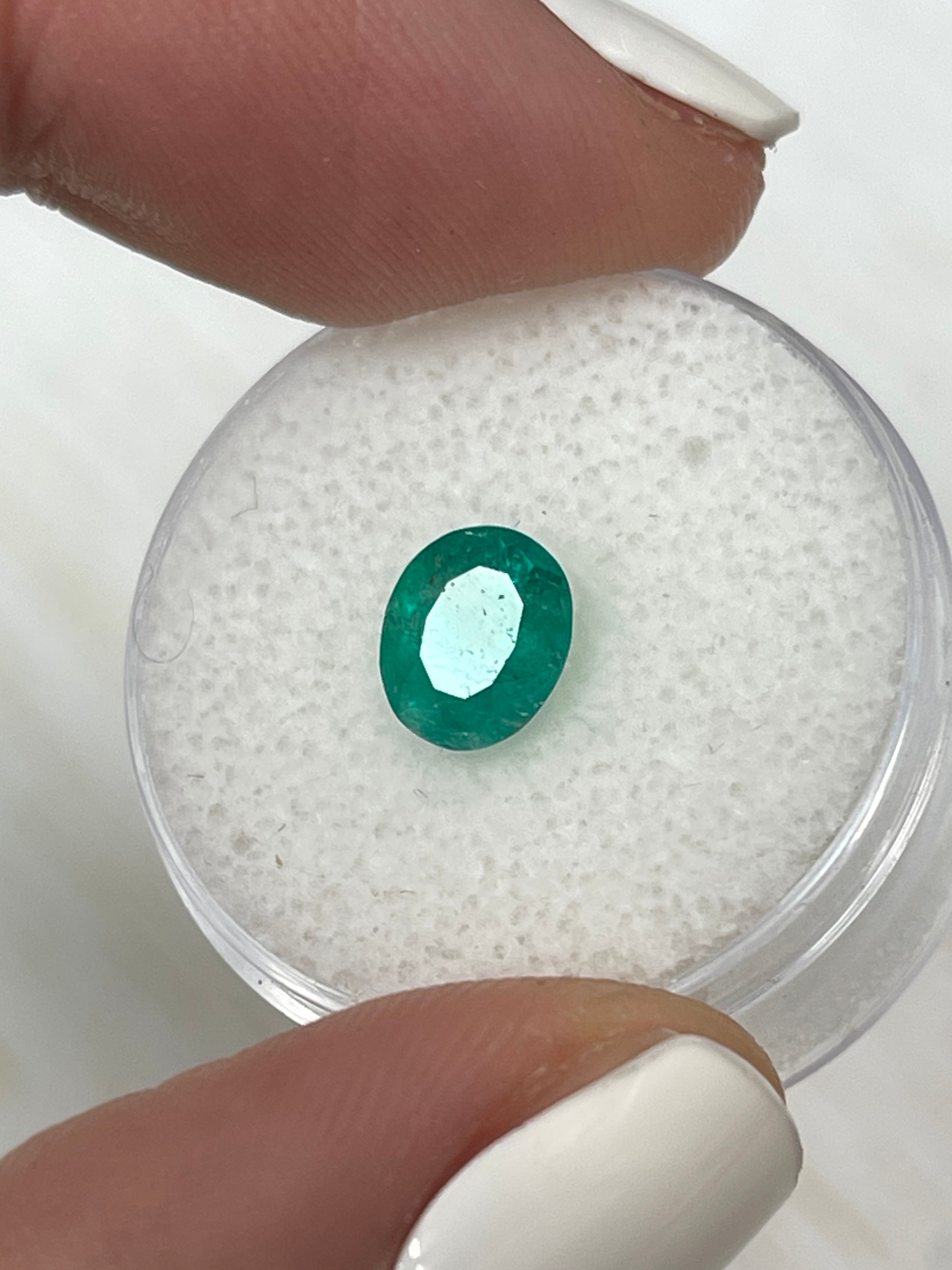 Oval cut 1.19 carat semi-transparent rich green Colombian emerald gemstone by JR Colombian Emeralds.