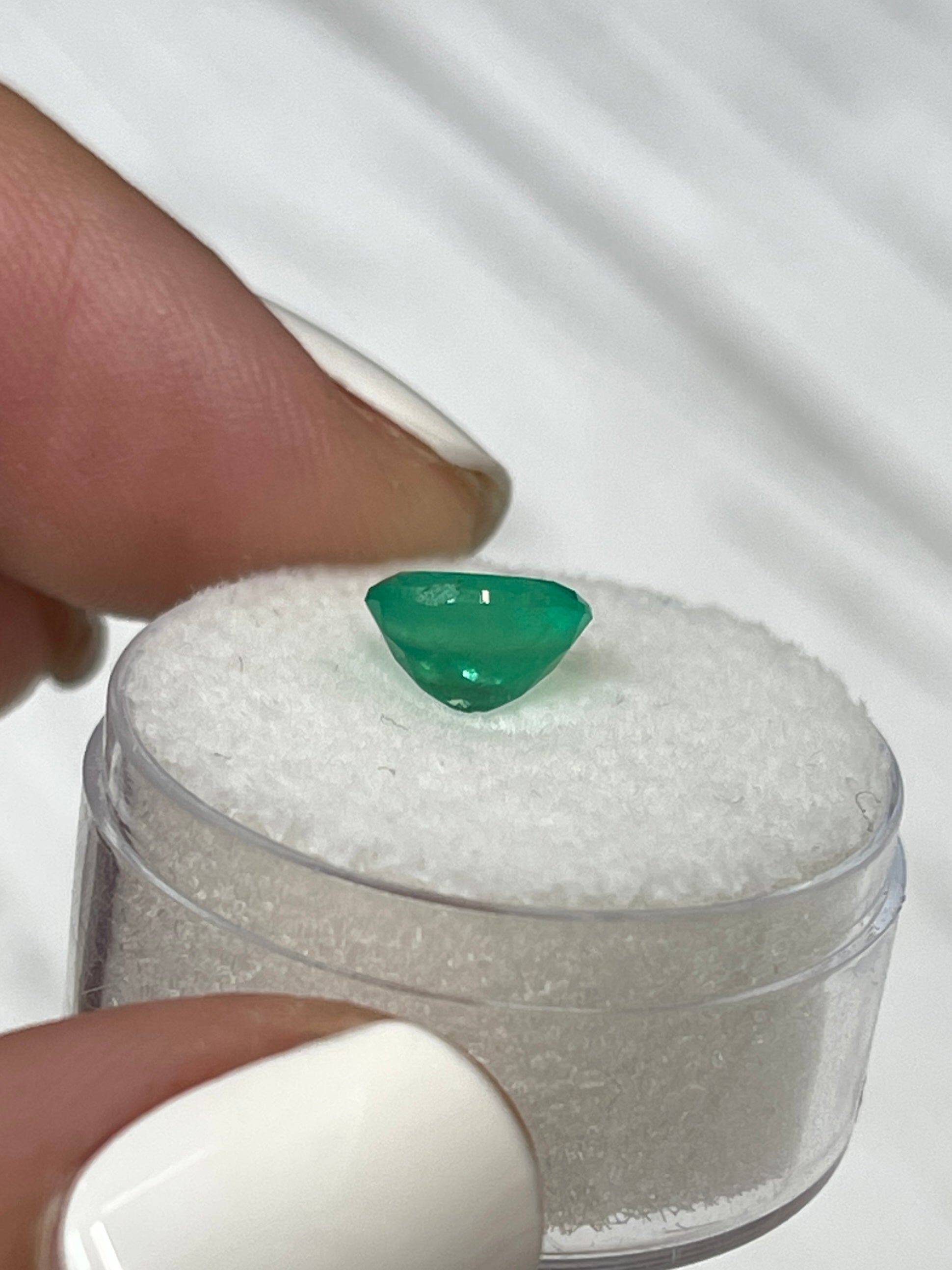 Bright apple green 1.40 carat natural Colombian emerald in oval cut, loose gemstone from JR Colombian Emeralds.