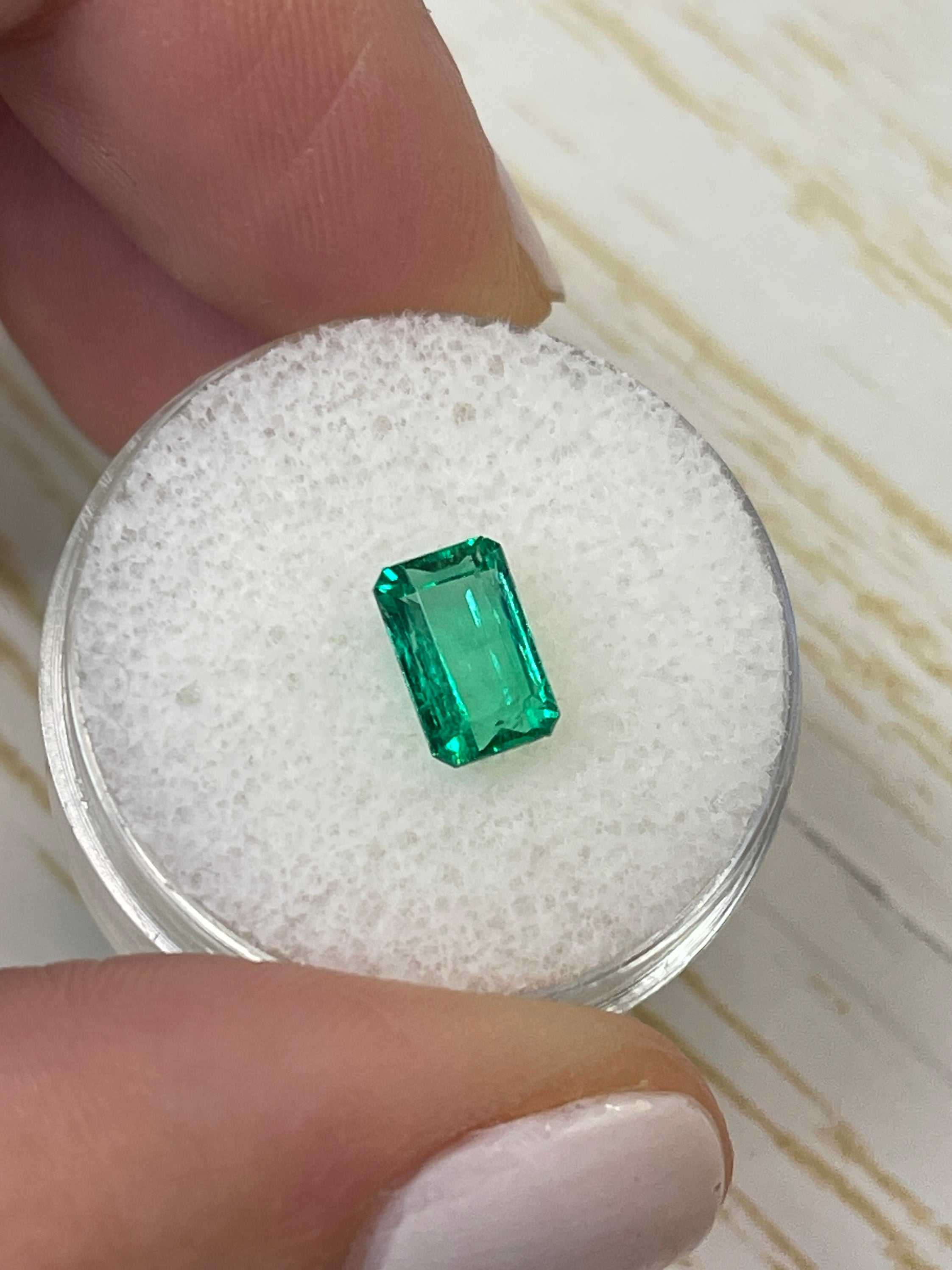 1.50 carat elongated Muzo green Colombian emerald loose gemstone with emerald cut, natural bright green color, from JR Colombian Emeralds.