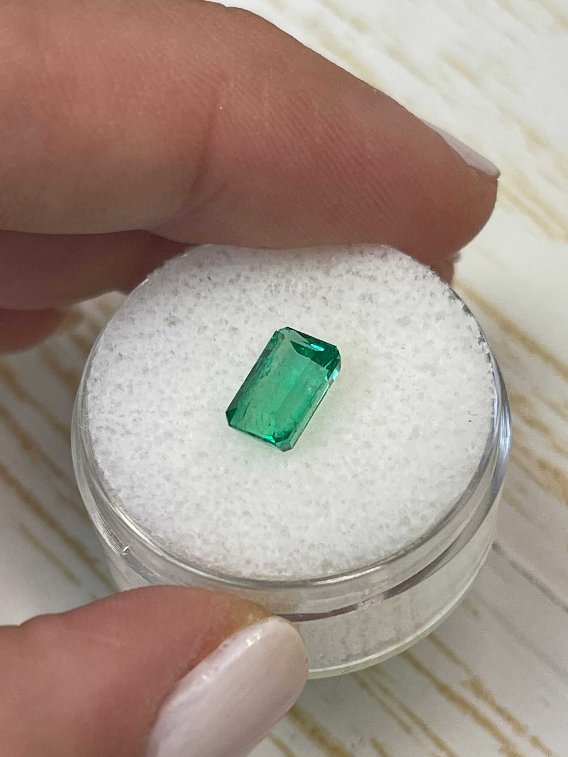 Elongated 8x5 mm Muzo green Colombian emerald loose gemstone, 1.50 carats, cut in an emerald shape, from JR Colombian Emeralds.