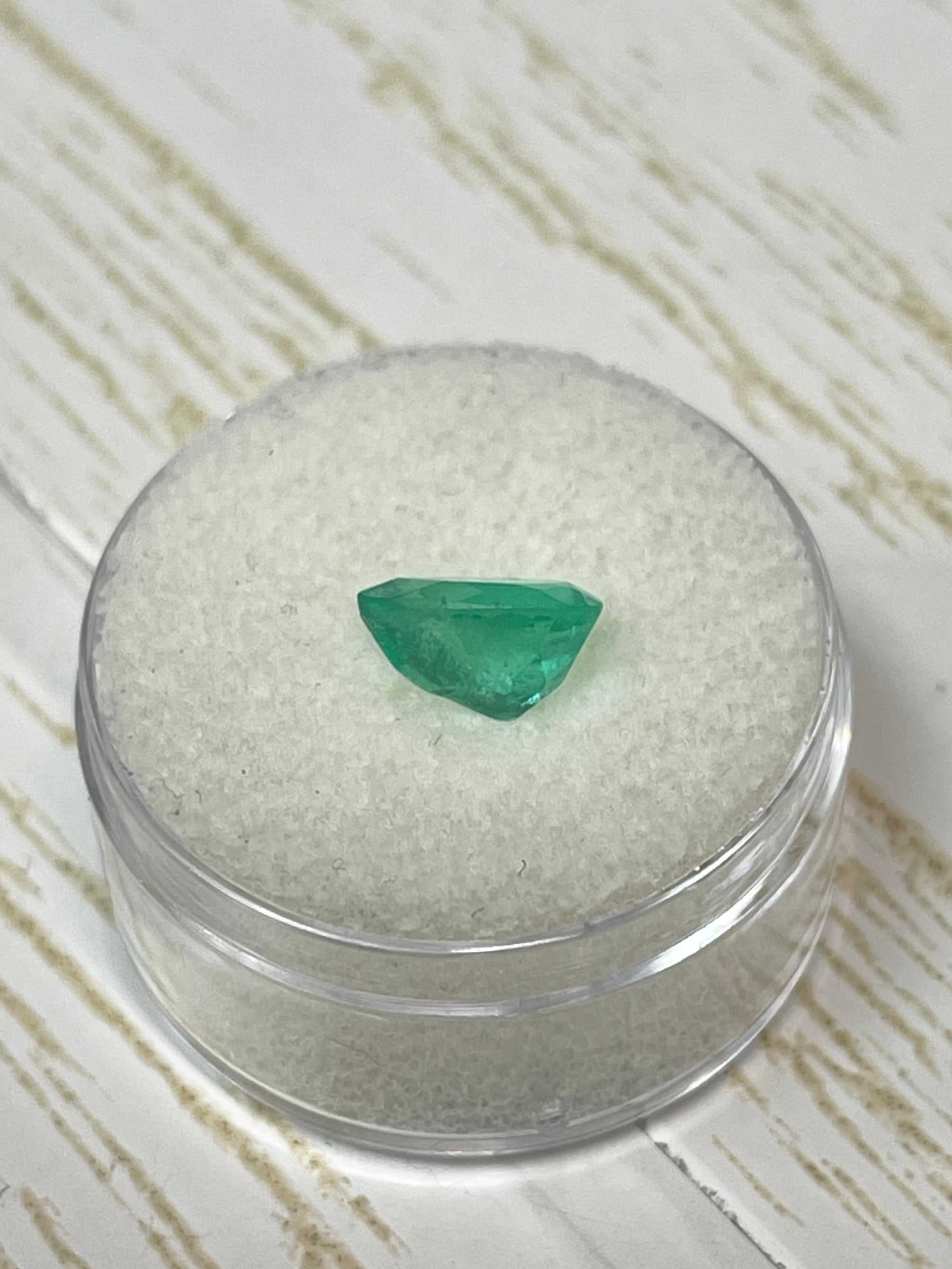 1.58 carat medium green natural Colombian emerald loose gemstone in pear cut, showcasing vibrant color and clarity.