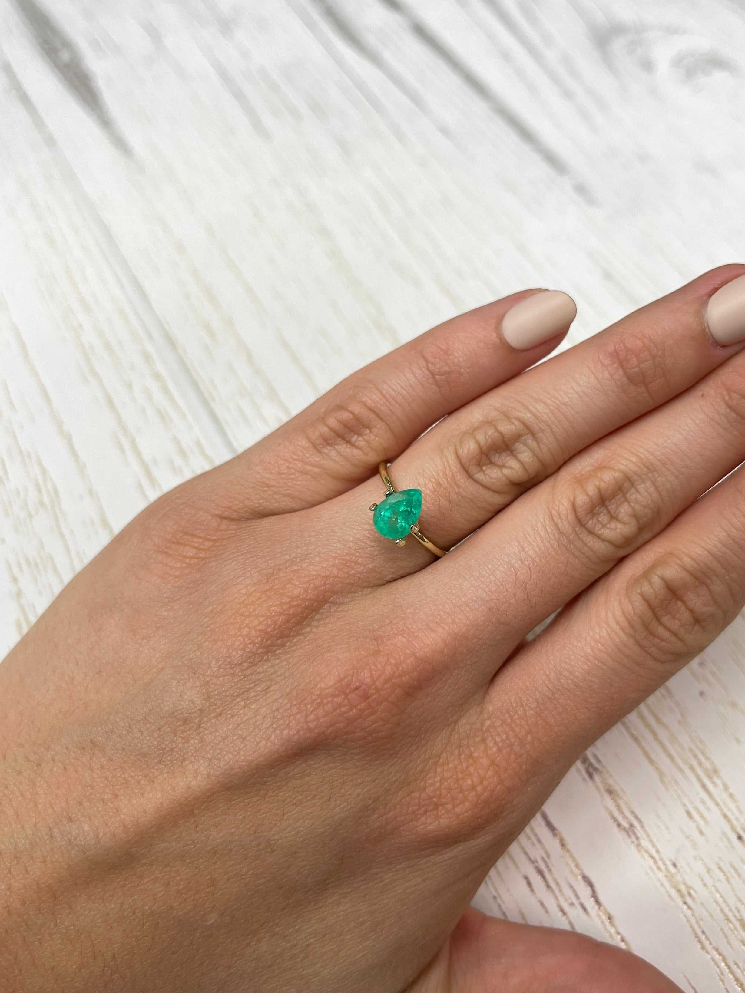 Medium green 1.58 carat natural Colombian emerald loose gemstone with pear cut, showcasing vibrant color and clarity.