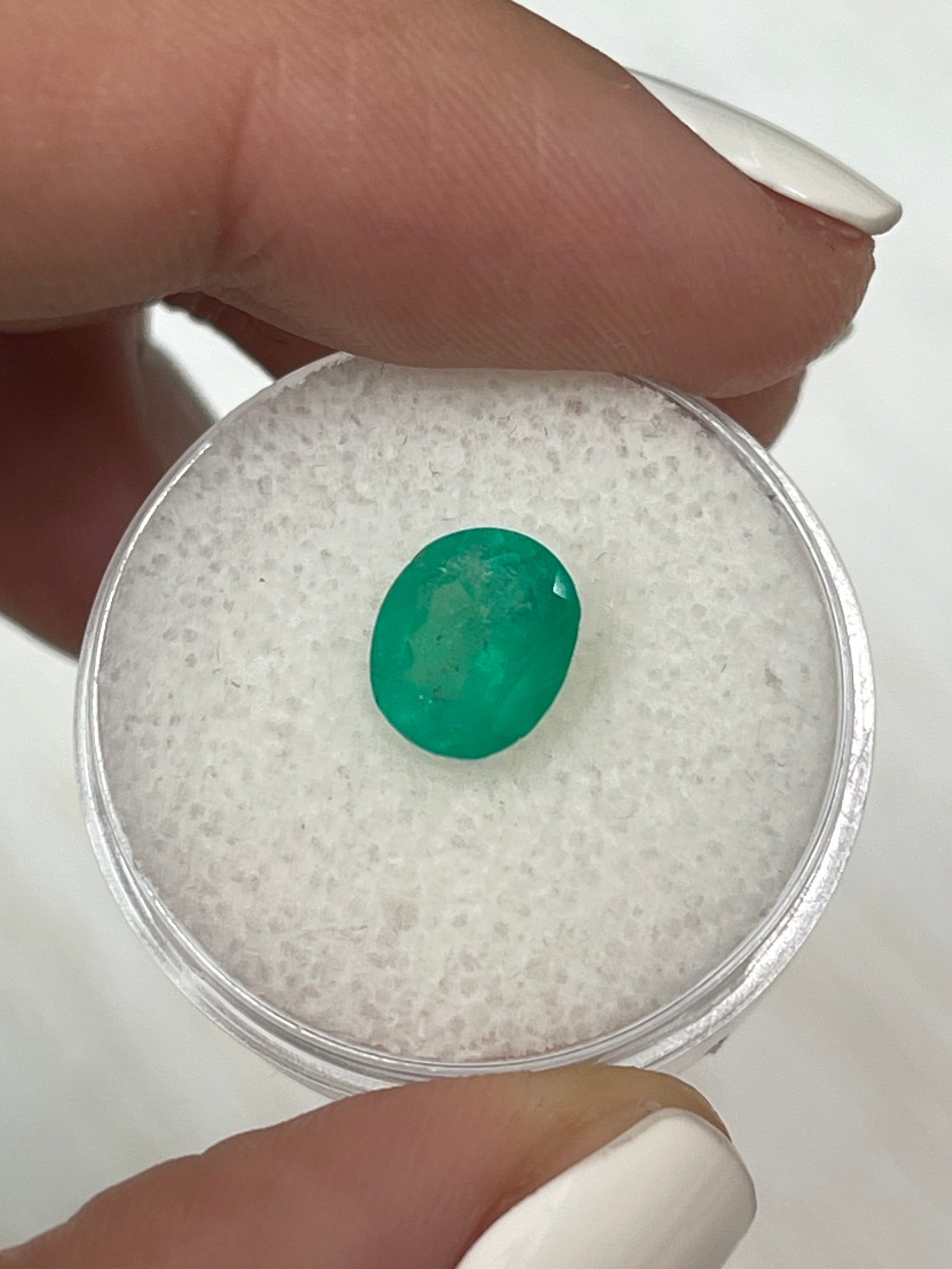 Loose 1.76 carat oval cut Colombian emerald by JR Colombian Emeralds, showcasing vibrant medium green natural gemstone.