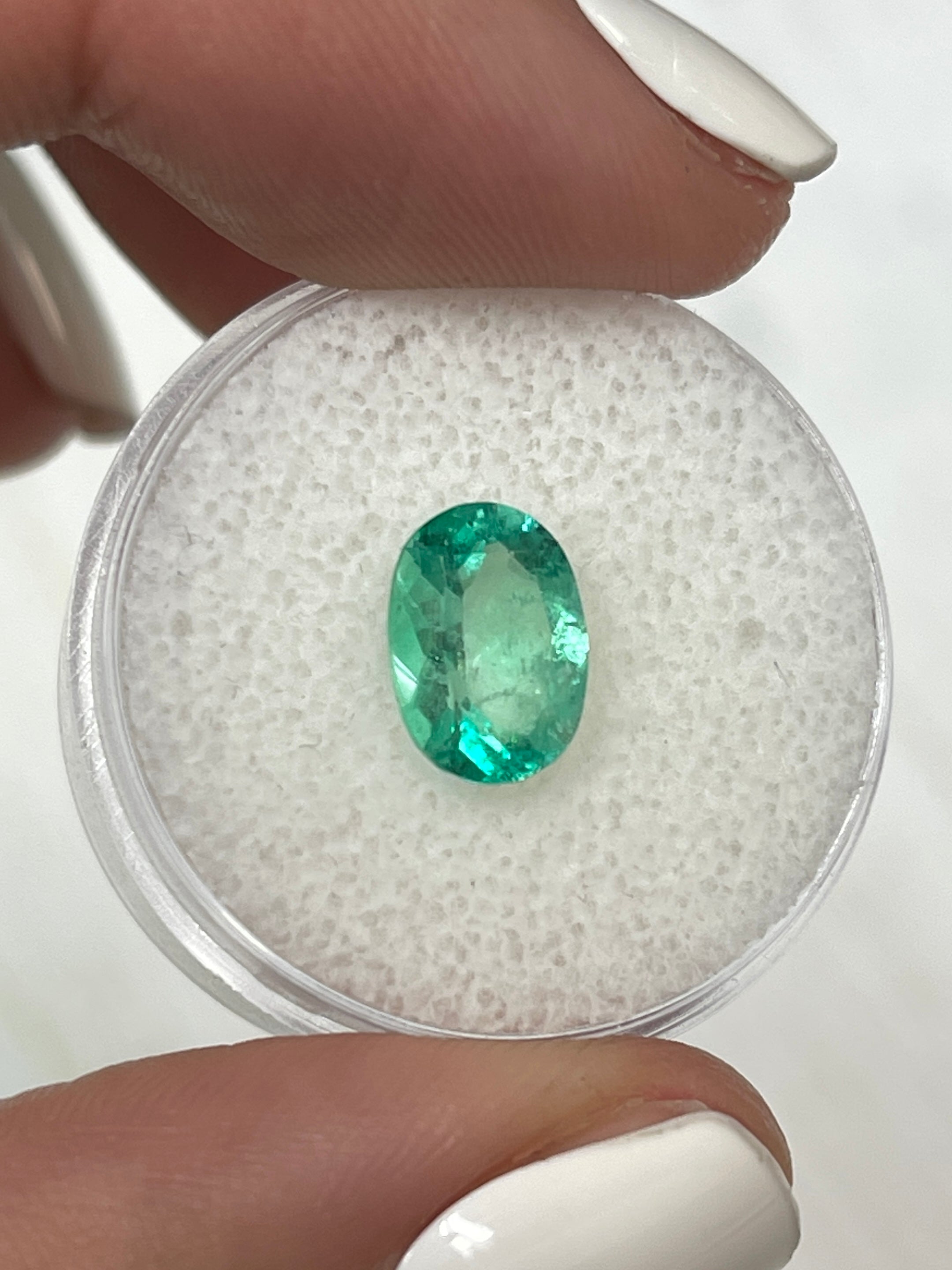 Medium-light green 1.77 carat oval cut Colombian emerald loose gemstone by JR Colombian Emeralds. Natural and vibrant.