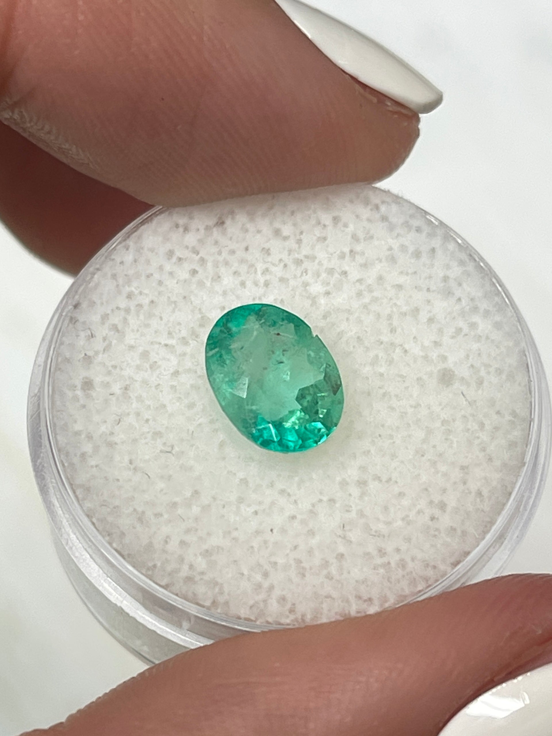 1.77 carat medium light green natural Colombian emerald loose oval cut gemstone by JR Colombian Emeralds.