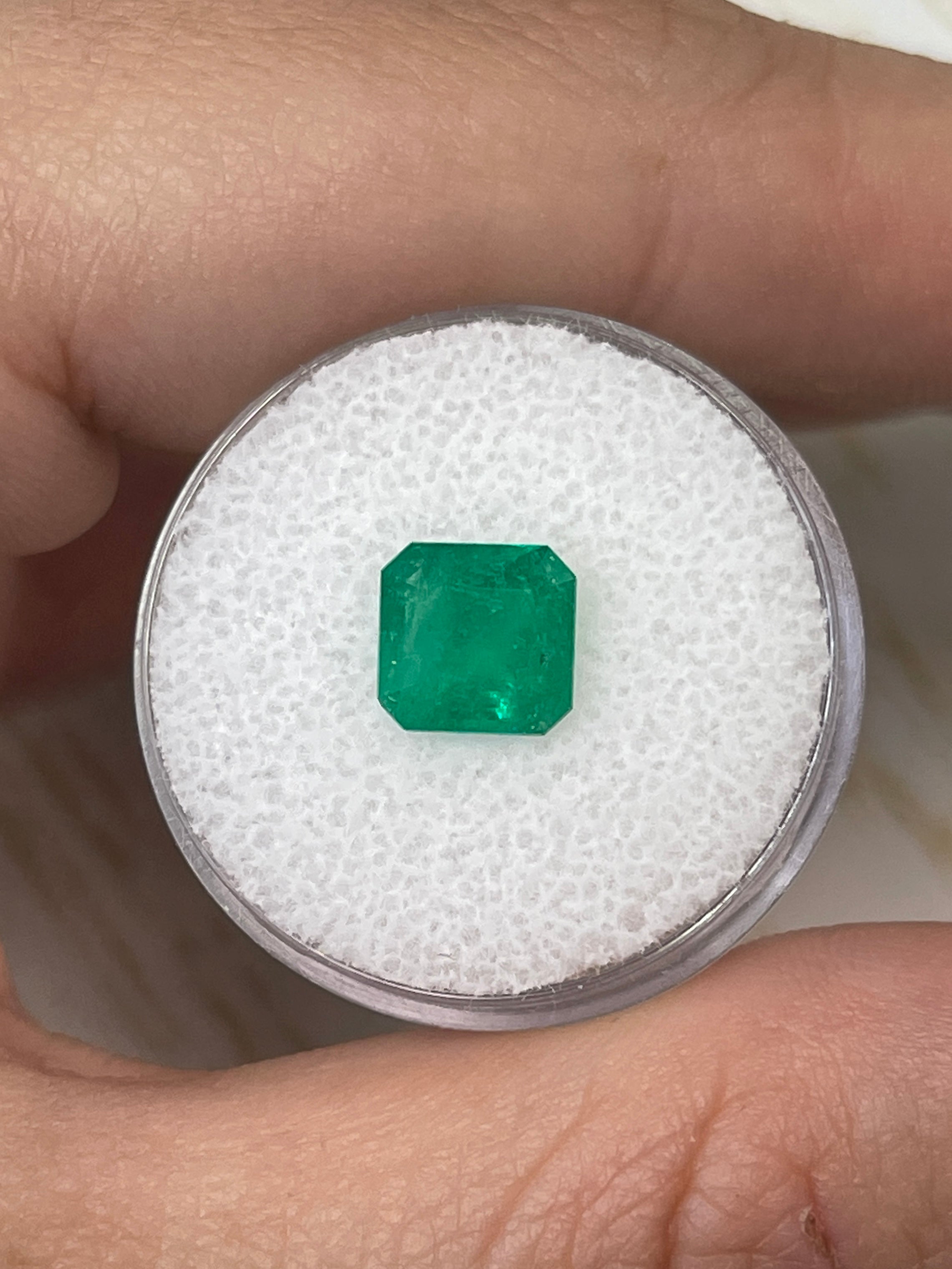 Natural 1.84 carat Colombian emerald loose gemstone in an 8x8mm Asscher cut, showcasing vibrant green color and clarity.