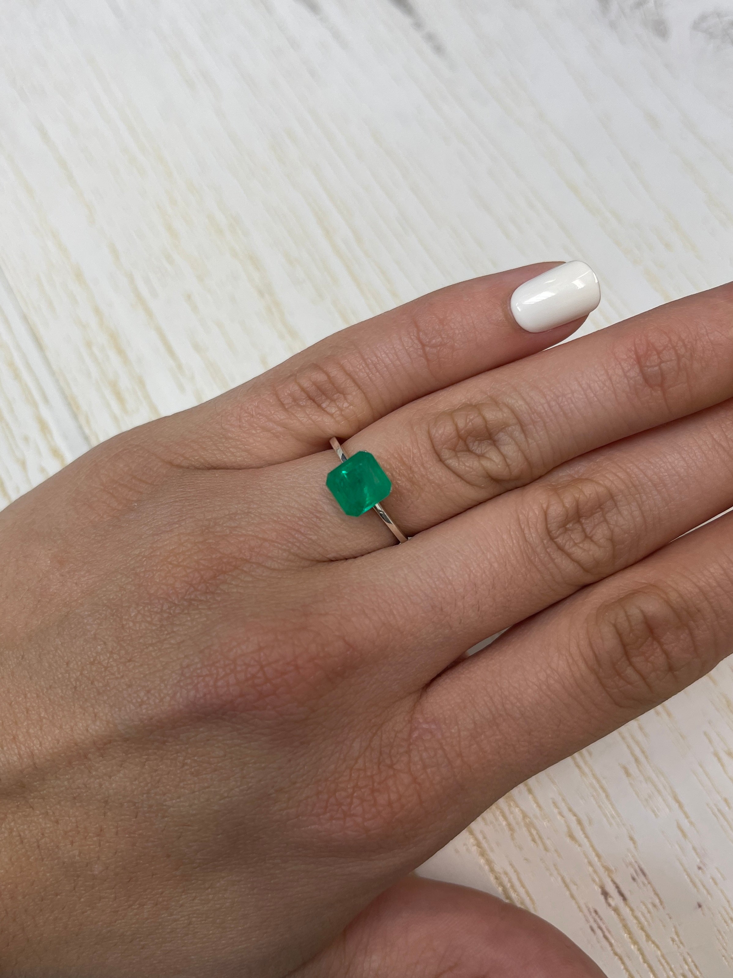 Natural 1.84 Carat Colombian Emerald loose Asscher cut gemstone, showcasing vibrant green color and clarity.