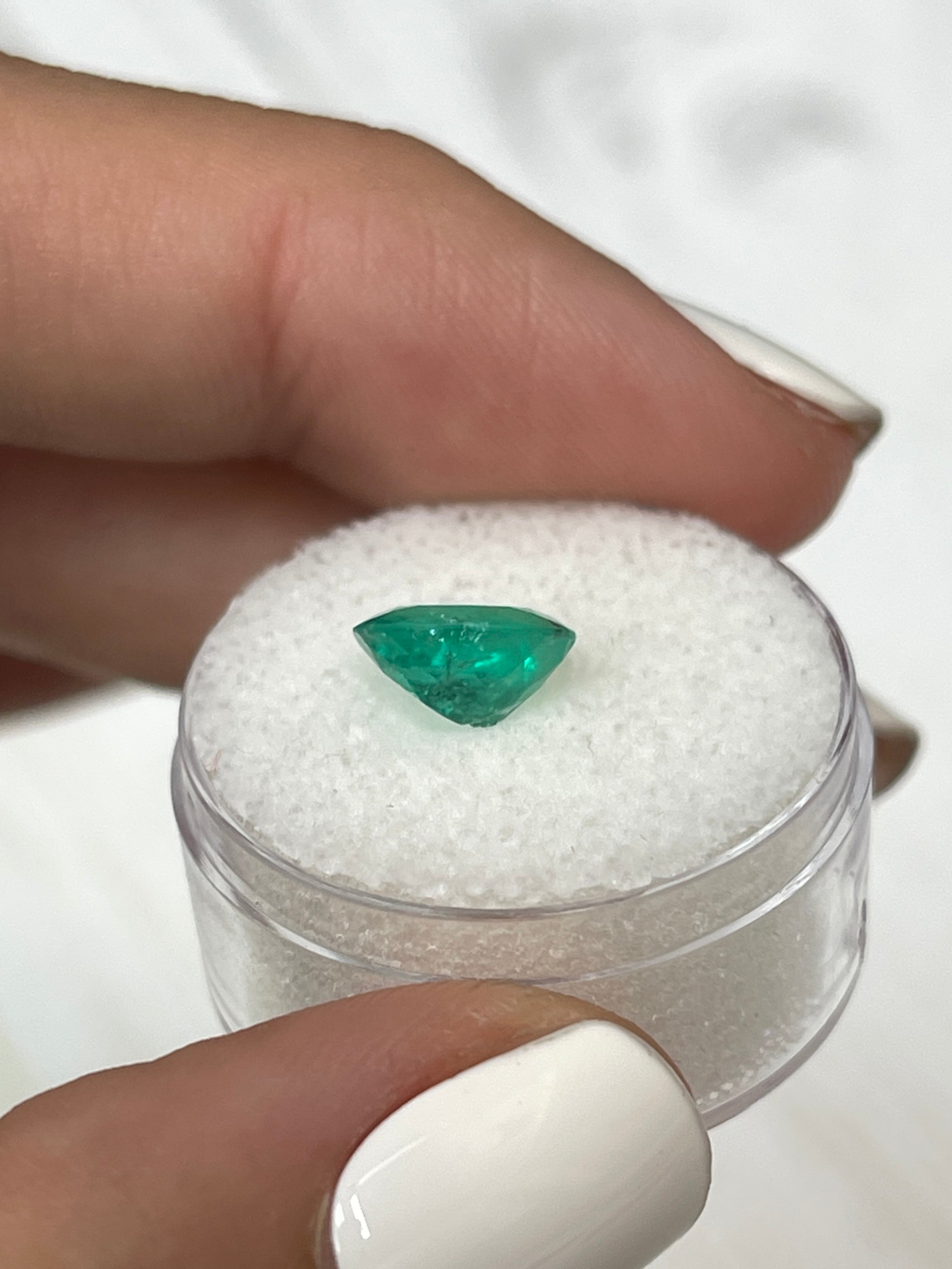 Oval cut 1.87 carat medium green natural Colombian emerald gemstone, loose with vibrant color and clarity.