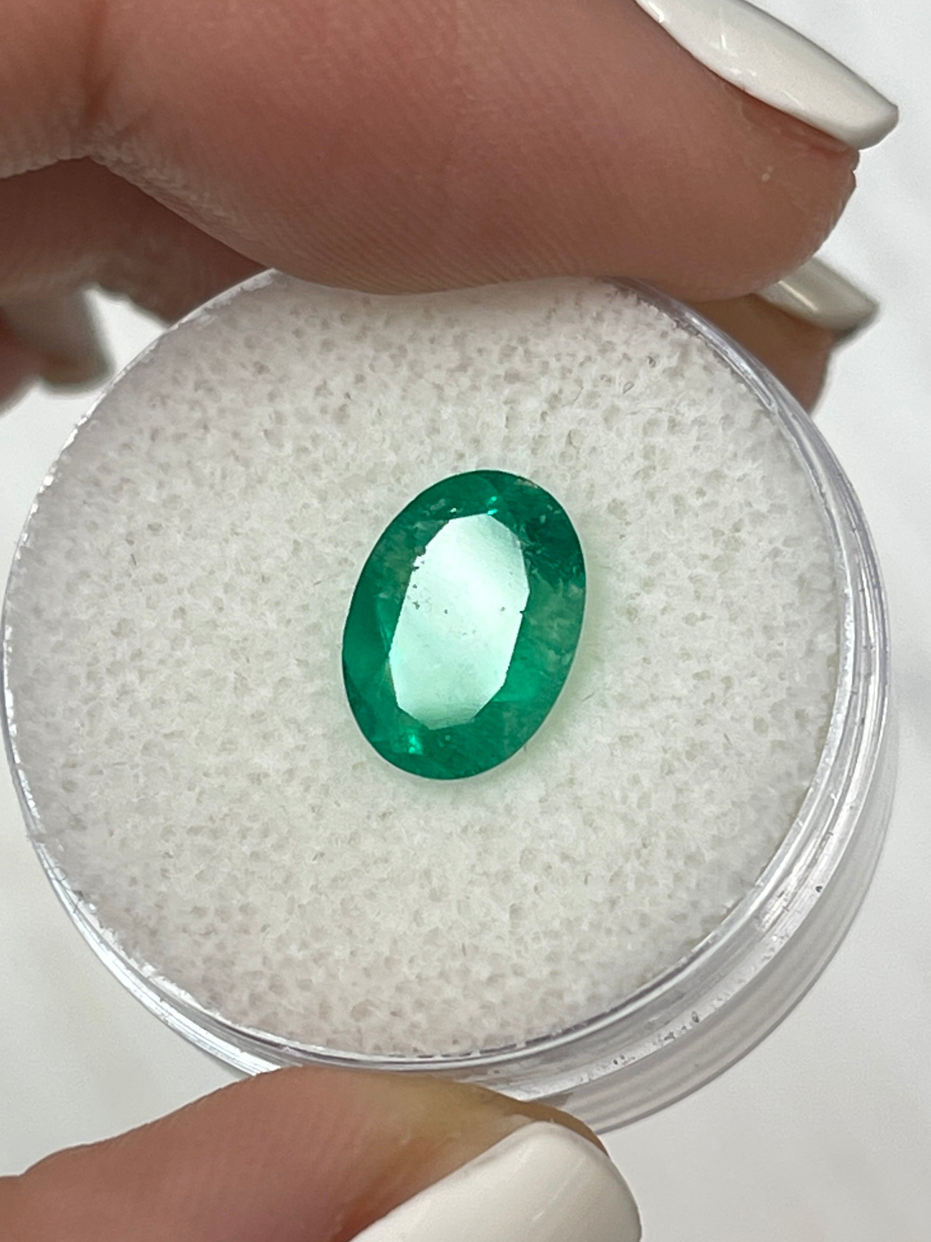 Loose 1.94 carat oval-cut green Colombian emerald from JR Colombian Emeralds, natural and vibrant with a polished finish.